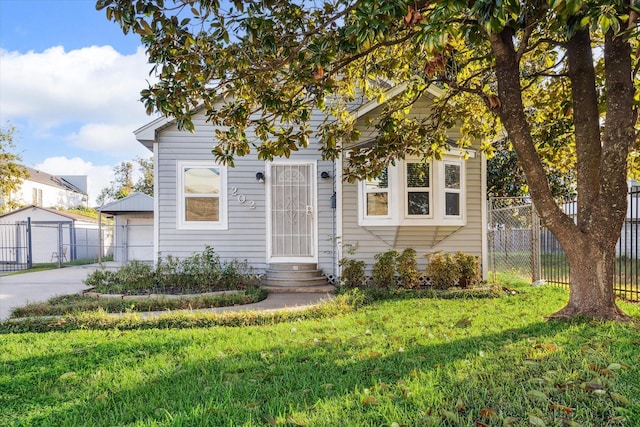 view of front of property featuring a garage and a front yard