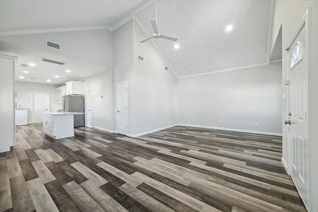 unfurnished living room with ceiling fan, dark hardwood / wood-style flooring, ornamental molding, and high vaulted ceiling