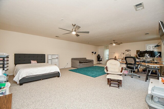 bedroom with carpet flooring, a textured ceiling, and ceiling fan