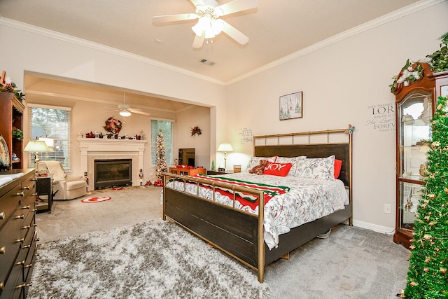 carpeted bedroom featuring ceiling fan and crown molding