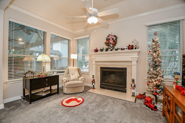 sitting room with carpet floors, ceiling fan, and ornamental molding