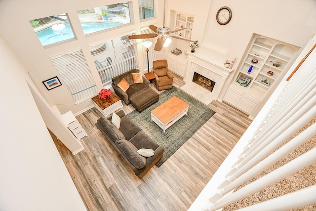 living room featuring light hardwood / wood-style flooring and a towering ceiling