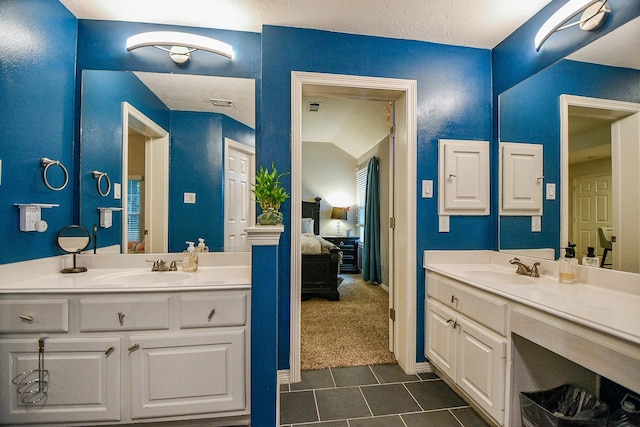 bathroom featuring vanity and vaulted ceiling