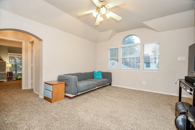 living area with carpet flooring, ceiling fan, and vaulted ceiling