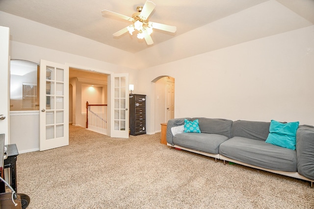 carpeted living room featuring ceiling fan and french doors