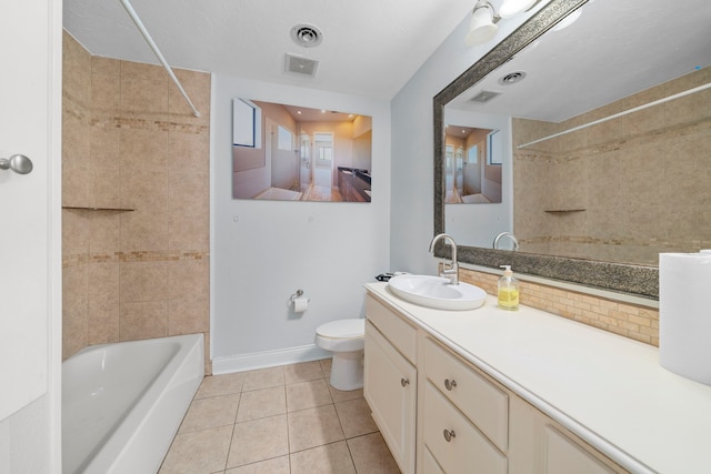 full bathroom with tile patterned flooring, vanity, toilet, and tiled shower / bath combo