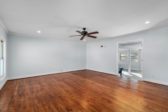 empty room featuring ceiling fan, wood-type flooring, and ornamental molding