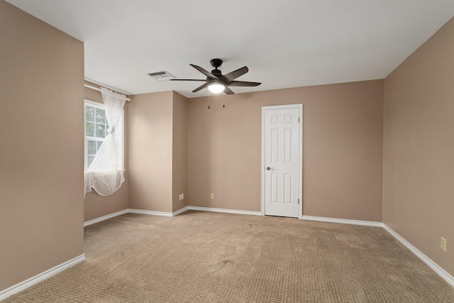 carpeted spare room featuring ceiling fan