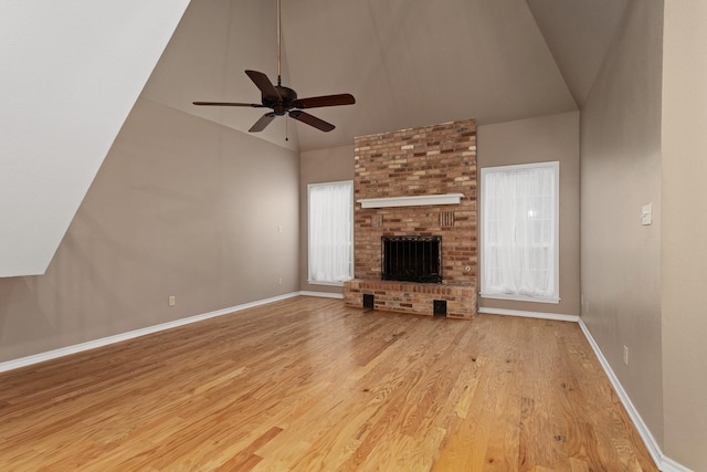 301 Stone Hill Dr Unit C, Brenham, TX 77833 - unfurnished living room with lofted ceiling, wood finished floors, a ceiling fan, baseboards, and a fireplace