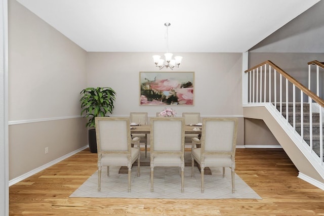 301 Stone Hill Dr Unit C, Brenham, TX 77833 - dining room featuring a chandelier, light wood-style flooring, stairway, and baseboards