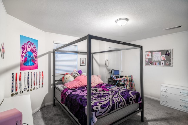 bedroom featuring a textured ceiling and carpet floors