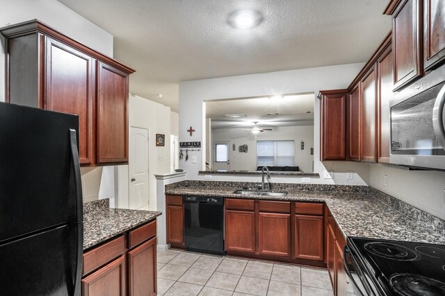 kitchen with dark stone counters, ceiling fan, sink, black appliances, and light tile patterned floors