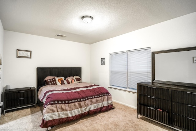 carpeted bedroom featuring a textured ceiling