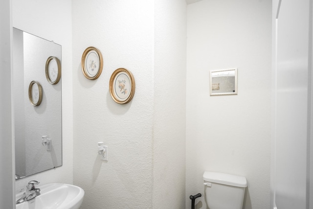 bathroom with toilet and sink