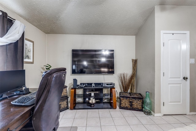 home office featuring light tile patterned flooring and a textured ceiling