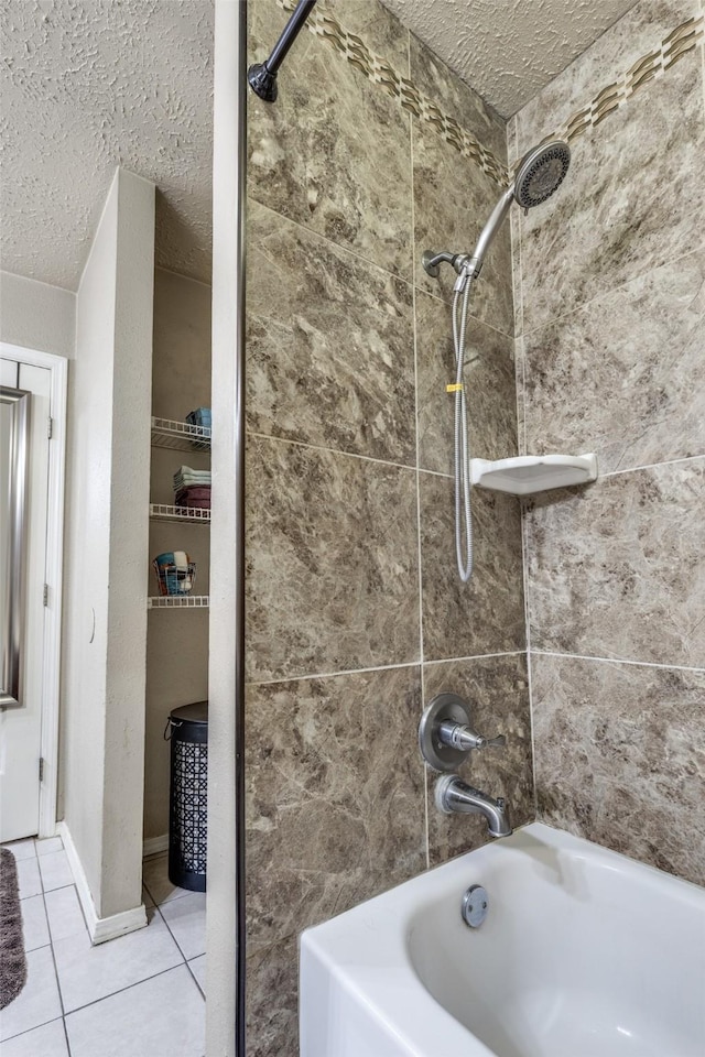 bathroom featuring tile patterned flooring, tiled shower / bath combo, and a textured ceiling