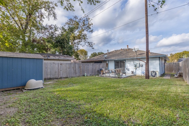 view of yard with a patio and a storage unit