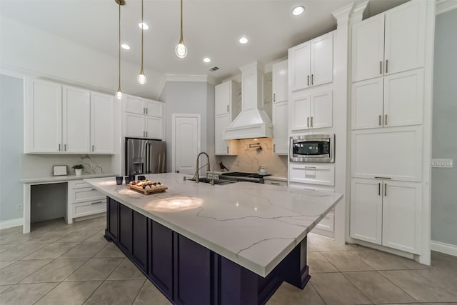 kitchen with a large island, sink, hanging light fixtures, premium range hood, and appliances with stainless steel finishes