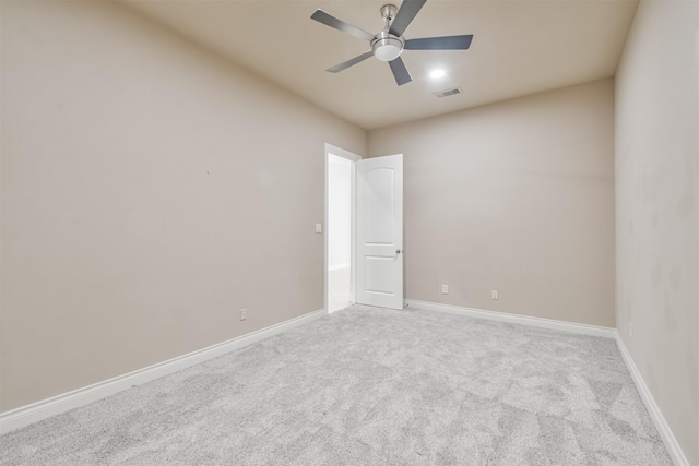 spare room with ceiling fan and light colored carpet