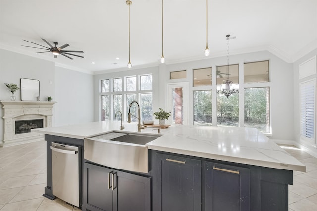 kitchen featuring an island with sink, dishwasher, sink, hanging light fixtures, and light stone counters