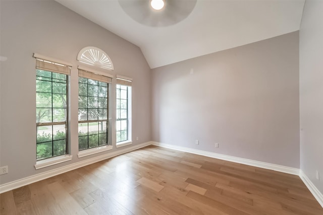 unfurnished room with vaulted ceiling, ceiling fan, and light hardwood / wood-style floors