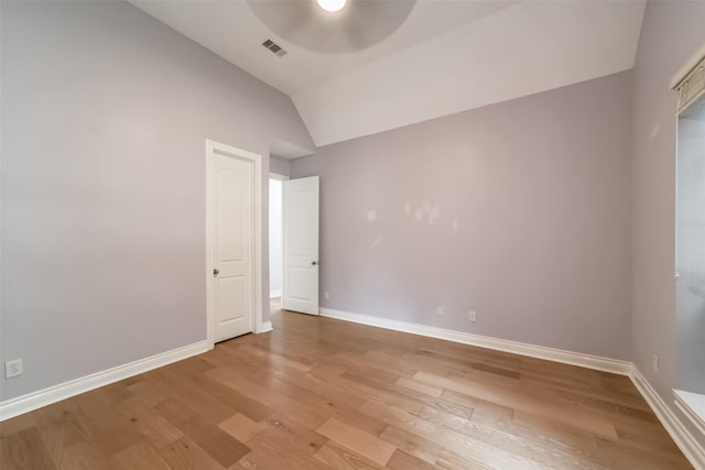 empty room featuring hardwood / wood-style flooring, ceiling fan, and lofted ceiling