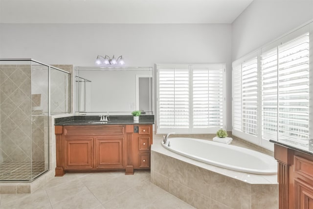 bathroom with vanity, tile patterned flooring, and plus walk in shower