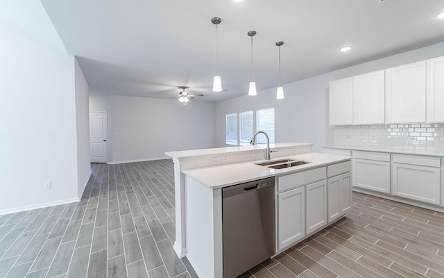 kitchen with white cabinetry, sink, stainless steel dishwasher, and light wood-type flooring