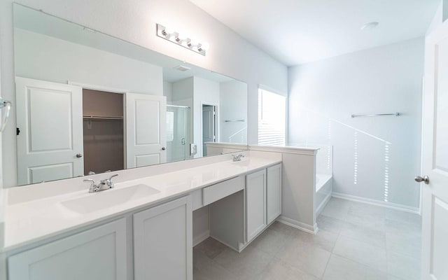 bathroom with tile patterned floors, vanity, and shower with separate bathtub