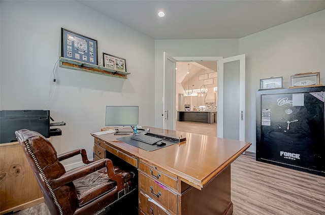 office area with lofted ceiling and light wood-type flooring