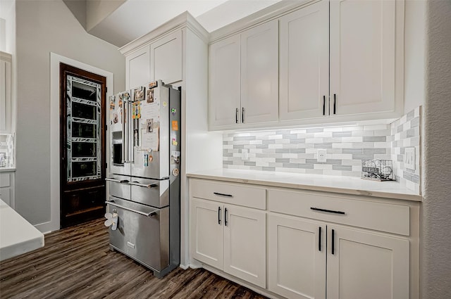 kitchen featuring white cabinets, decorative backsplash, dark hardwood / wood-style flooring, and stainless steel refrigerator with ice dispenser