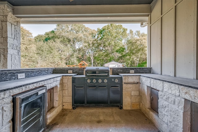 view of patio / terrace featuring beverage cooler and an outdoor kitchen