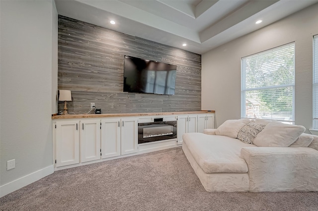 living room with wood walls and light colored carpet