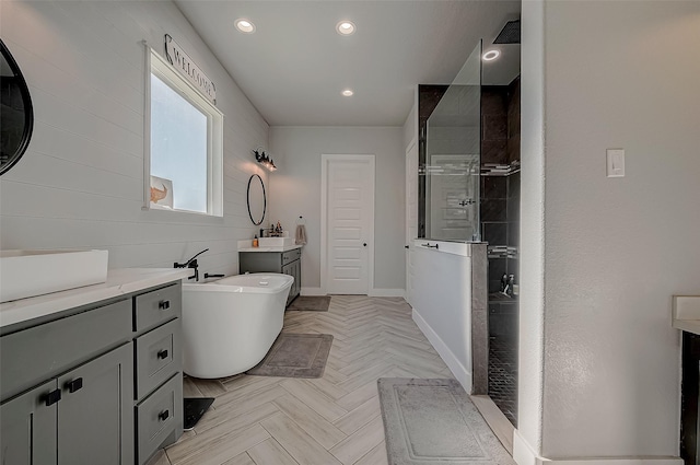 bathroom with plus walk in shower, vanity, and parquet floors