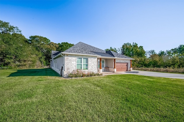 view of front of home with a garage and a front lawn