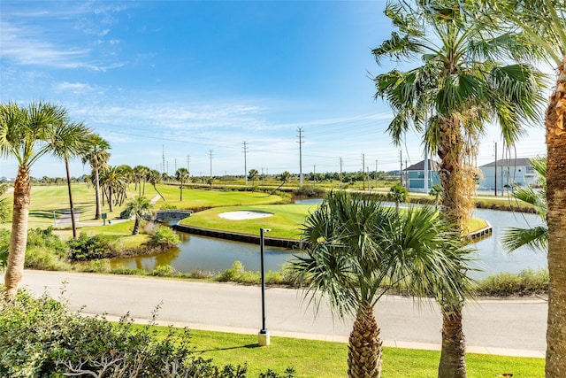 view of home's community with a yard and a water view