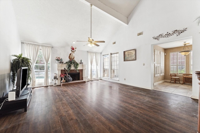 unfurnished living room with ceiling fan, wood-type flooring, high vaulted ceiling, beamed ceiling, and a fireplace