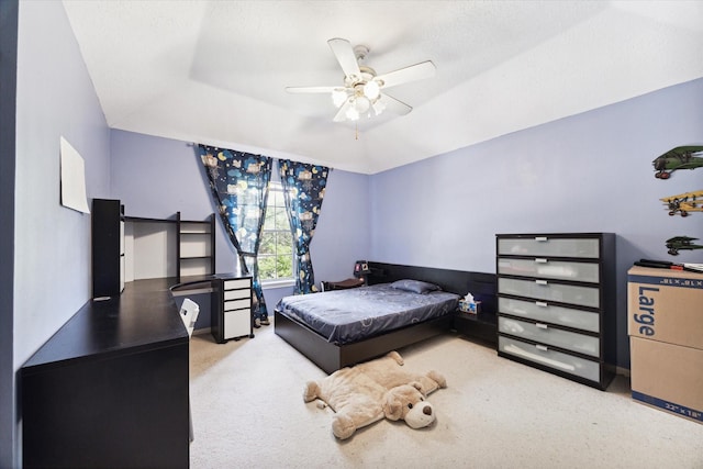 carpeted bedroom featuring a textured ceiling and ceiling fan