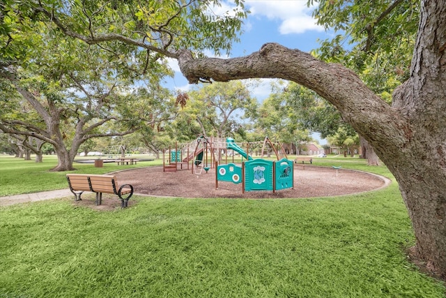 view of playground with a lawn