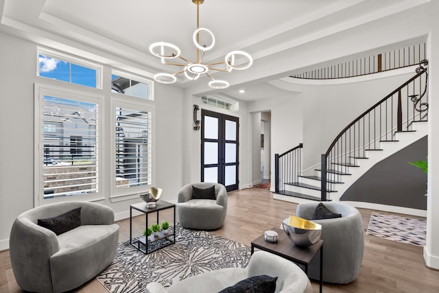 living room with wood-type flooring and an inviting chandelier