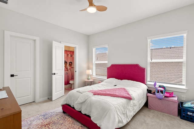 carpeted bedroom featuring ensuite bath and ceiling fan