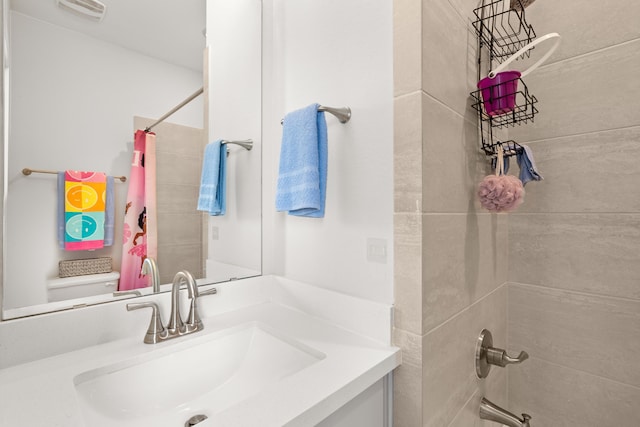 full bathroom with shower / tub combo with curtain, vanity, and toilet