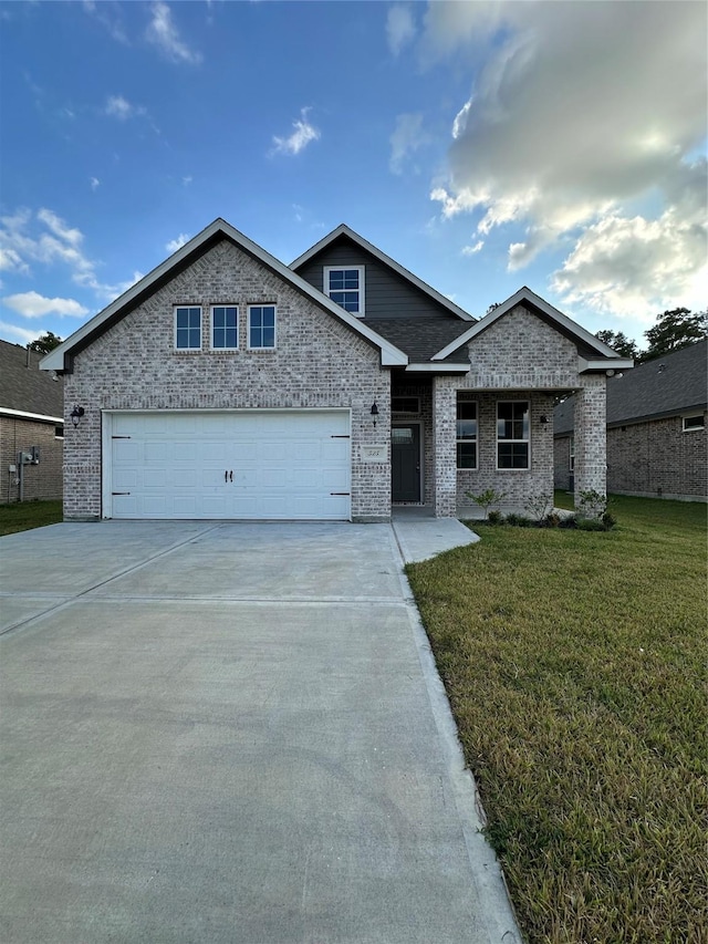 view of front of property featuring a garage and a front lawn