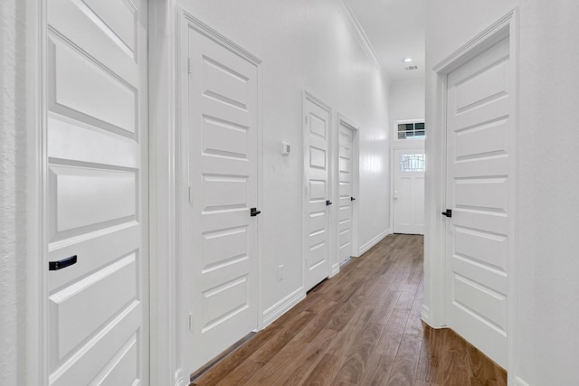525 Little Spring Ct, Anahuac, TX 77514 - hallway featuring dark wood finished floors, baseboards, and crown molding