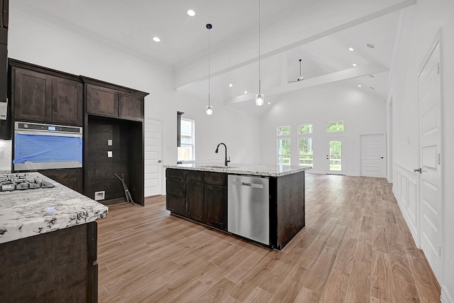 525 Little Spring Ct, Anahuac, TX 77514 - kitchen with stainless steel appliances, recessed lighting, a sink, dark brown cabinets, and light wood-style flooring