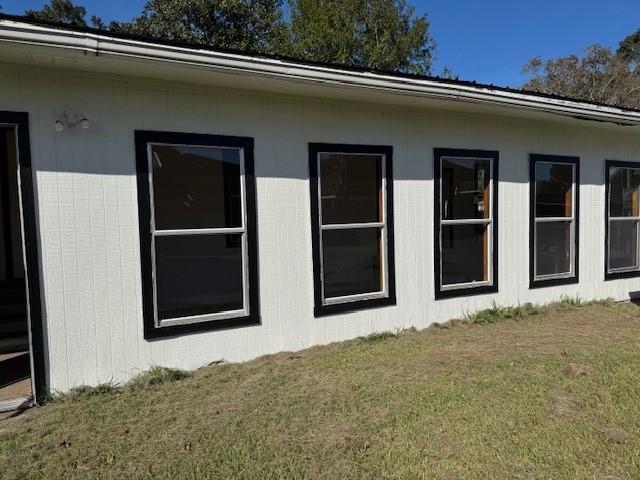 view of side of property featuring a yard