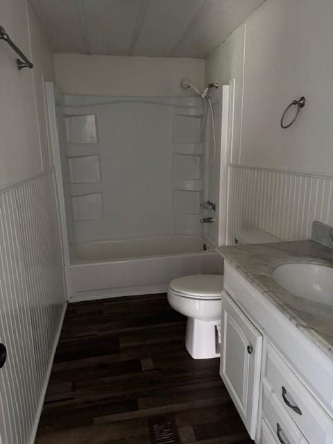 full bathroom with shower / bathing tub combination, vanity, wood-type flooring, and toilet