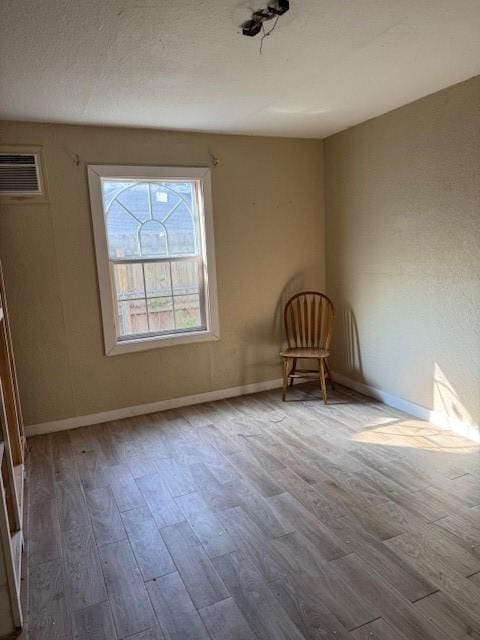 empty room with hardwood / wood-style flooring