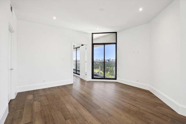 unfurnished room featuring dark hardwood / wood-style flooring