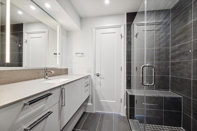 bathroom with vanity and a shower with shower door